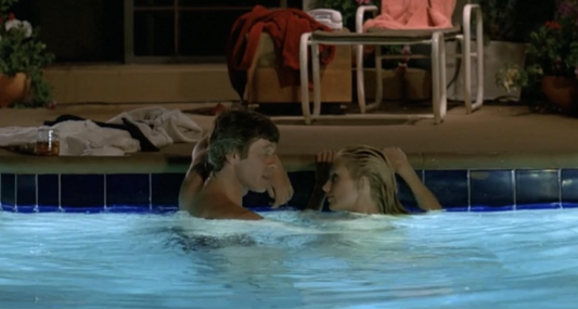 two people in a pool looking at each other